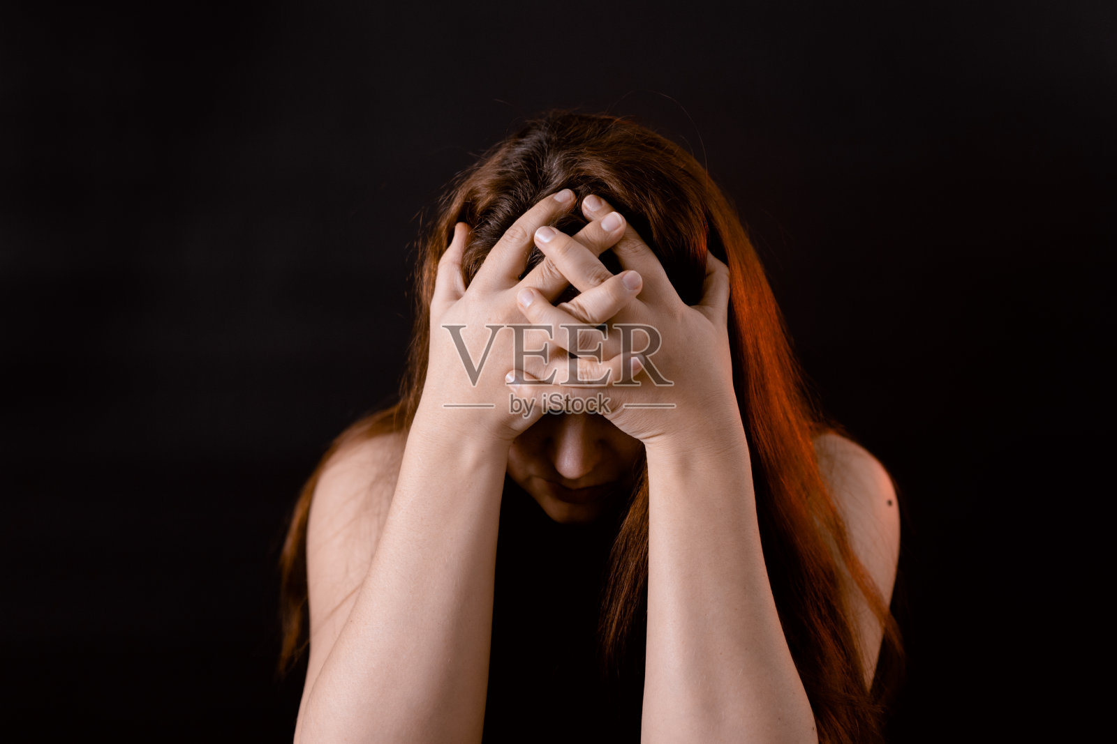 有自卑情结的女人用手捂住脸。沮丧的女孩，内向。情感，生活困难。照片摄影图片