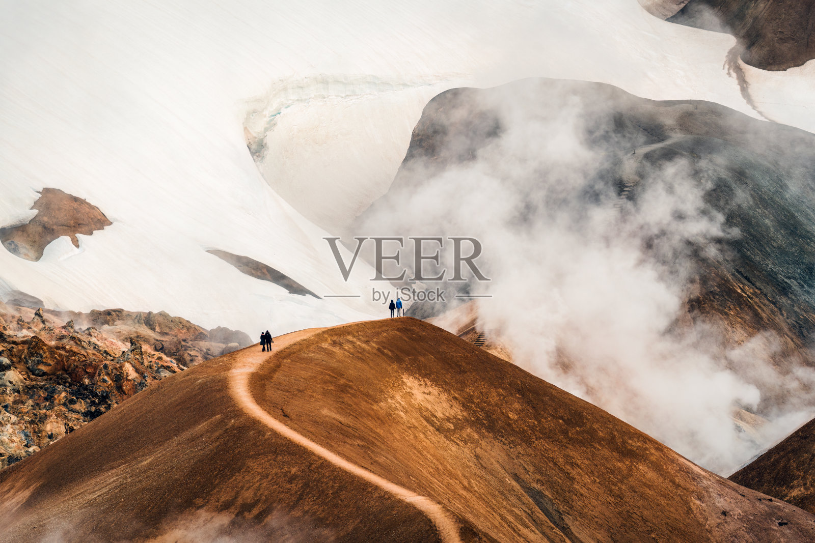 冰岛高地夏季的硫磺烟雾和游客徒步旅行的Kerlingarfjoll火山山脉景观照片摄影图片