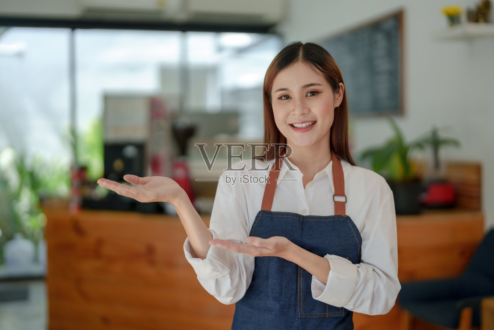 微笑的亚洲女人咖啡店的老板站在那里等着开门，等着客户服务，微笑着等着客户服务。照片摄影图片