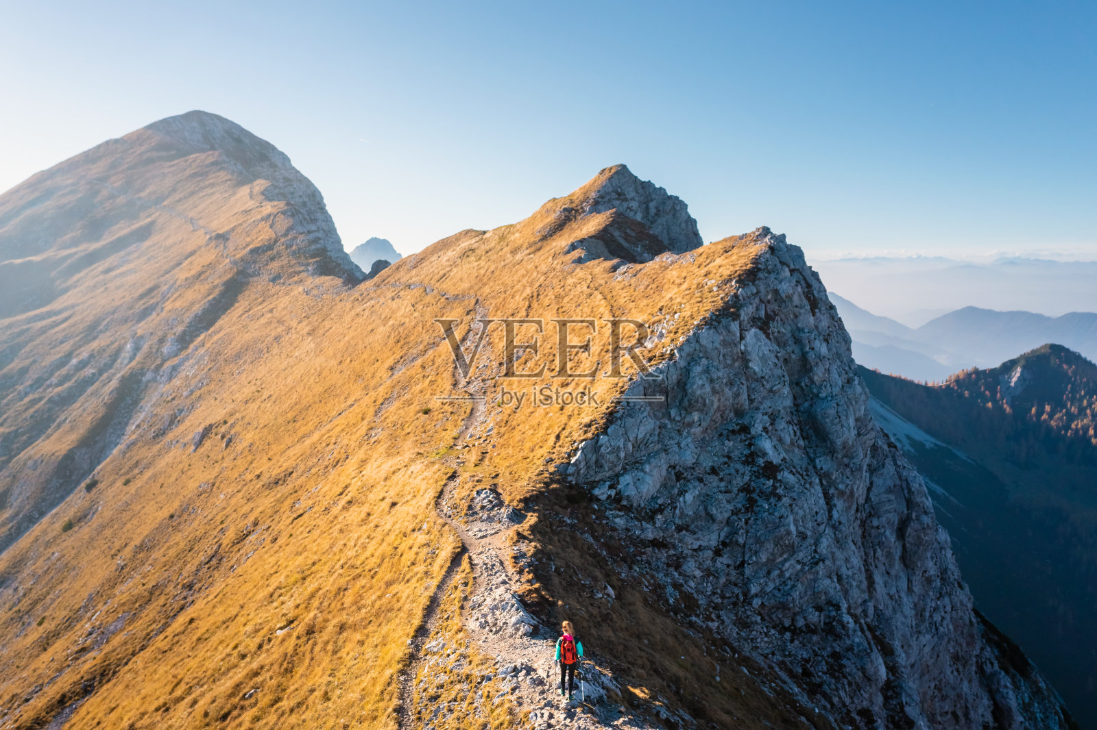 手持登山杖徒步旅行的妇女照片摄影图片