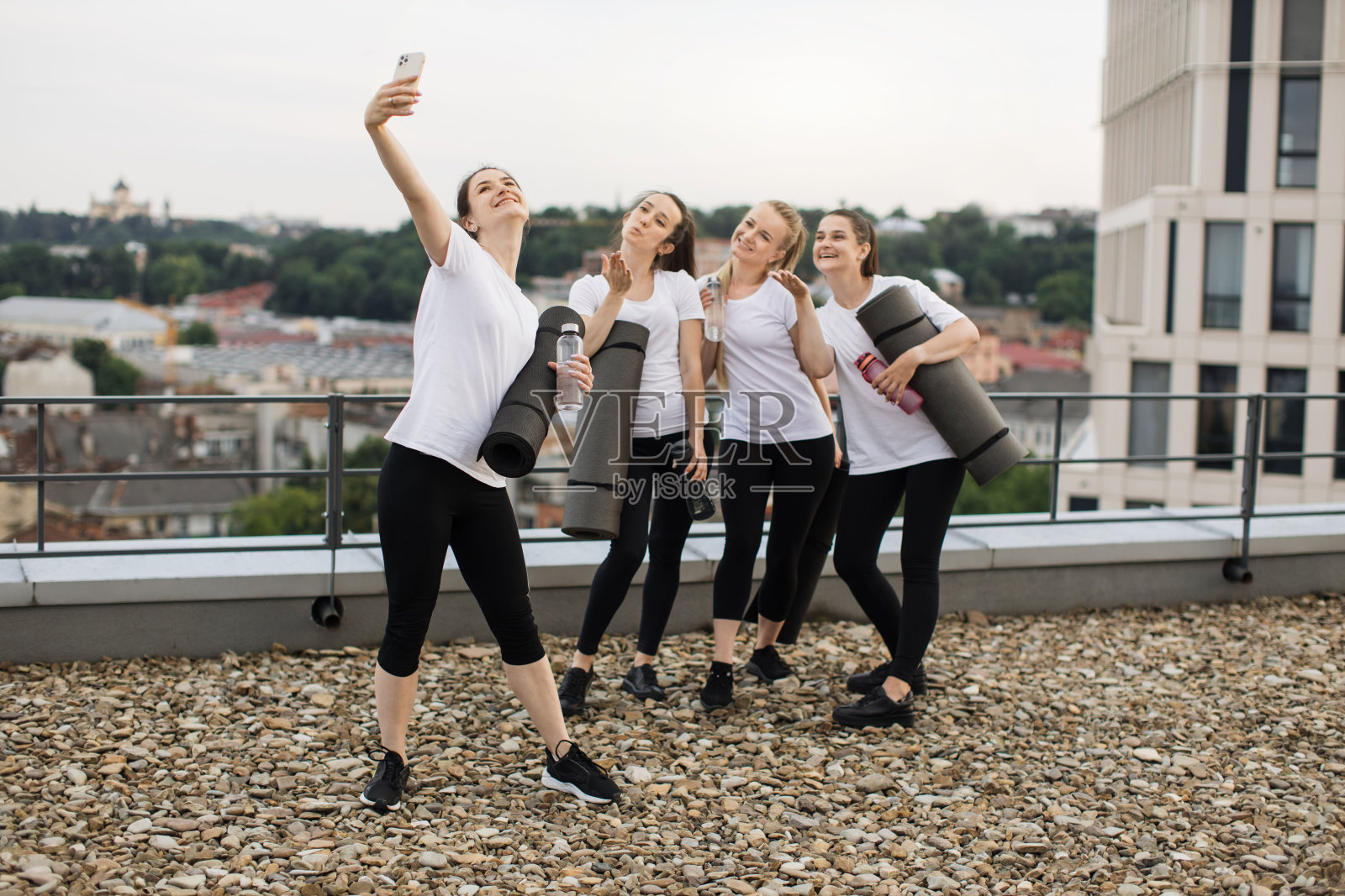 瑜伽练习者在屋顶露台上用手机自拍照片摄影图片