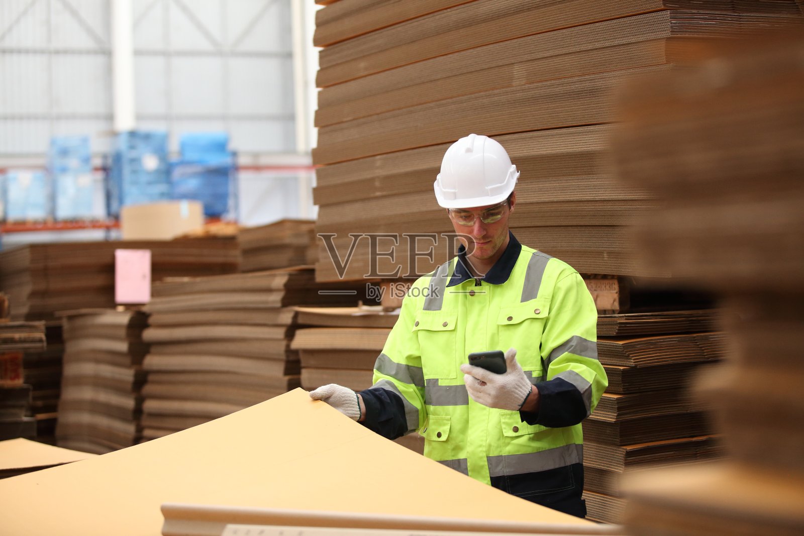 在工厂工作的工人或工程师穿着安全制服，安全帽和安全眼镜，形象是安全理念或快乐的工作场所照片摄影图片