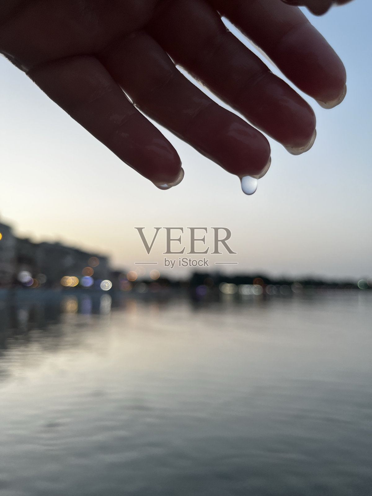 一滴水从手上滴下来照片摄影图片