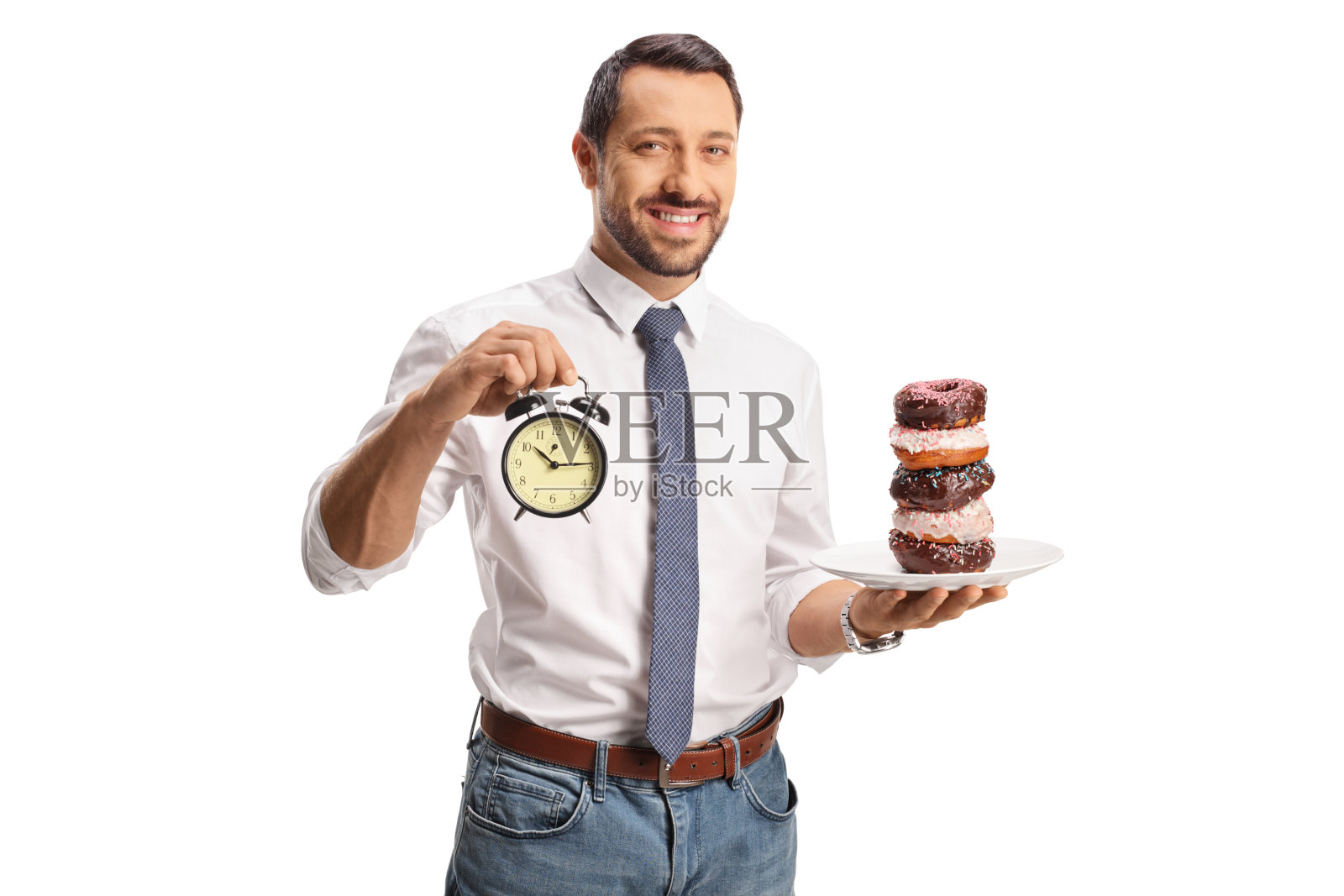 一个人拿着一个盘子里的甜甜圈和一个闹钟照片摄影图片