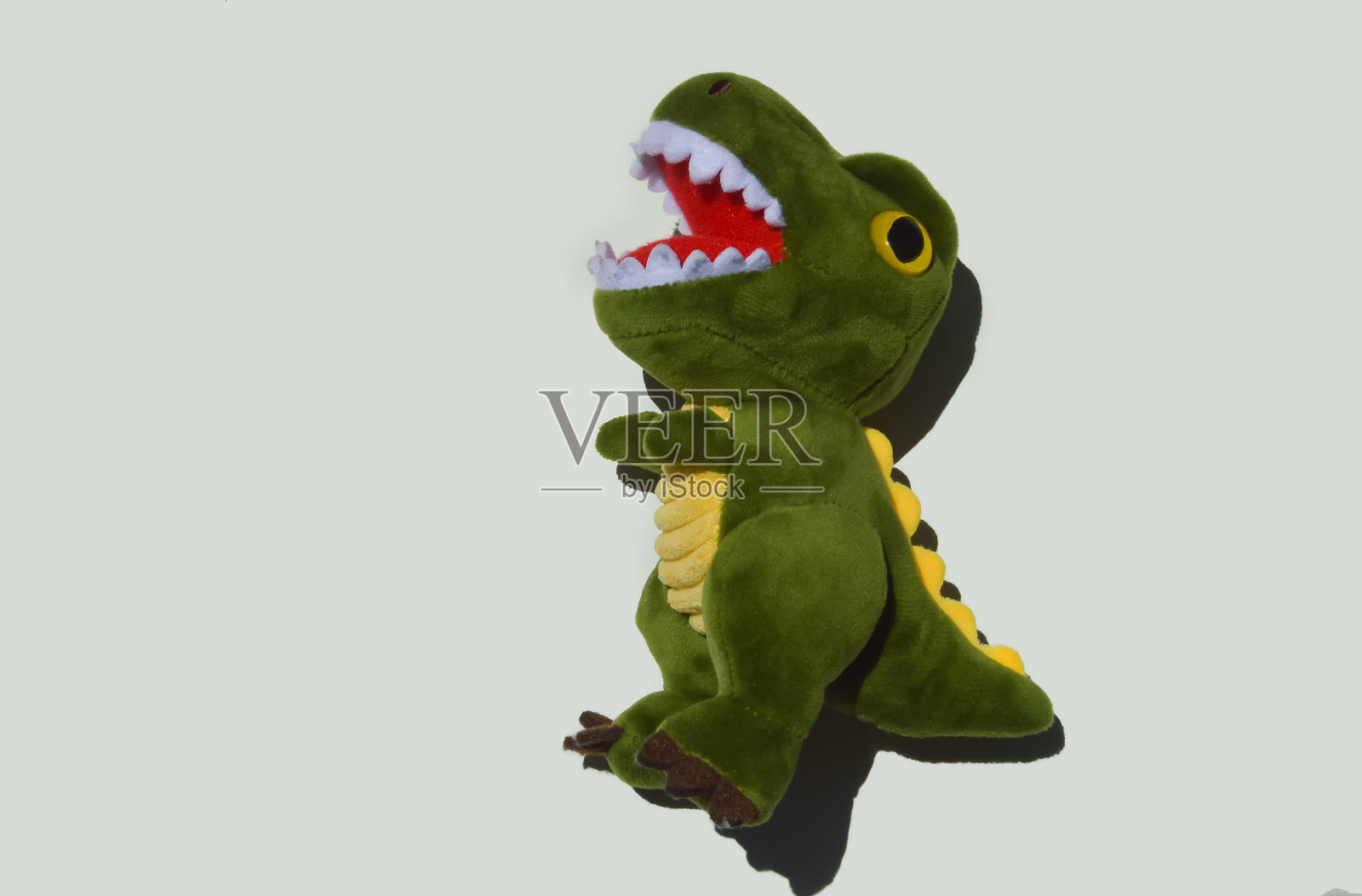 毛绒儿童玩具，绿色恐龙。装饰背景照片摄影图片