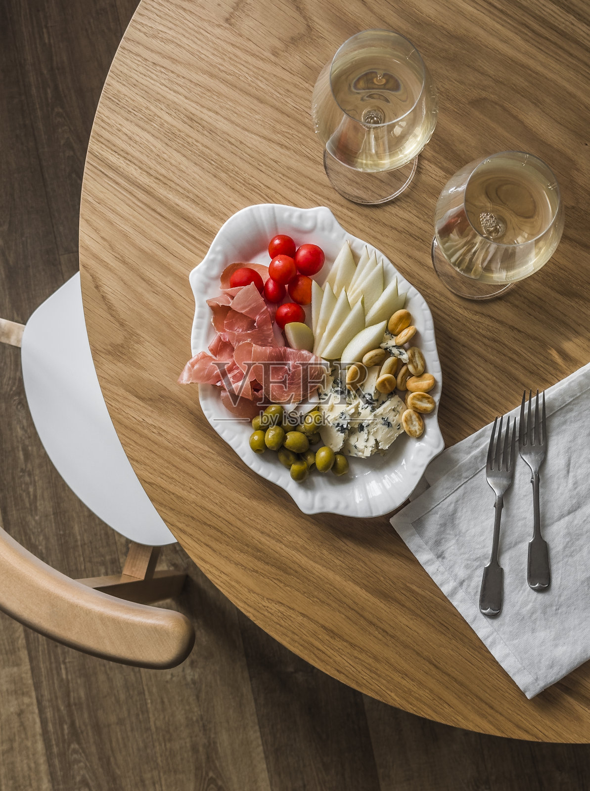 美味的开胃酒-白葡萄酒和一盘小吃，开胃菜，餐前小吃在木制背景，俯视图照片摄影图片