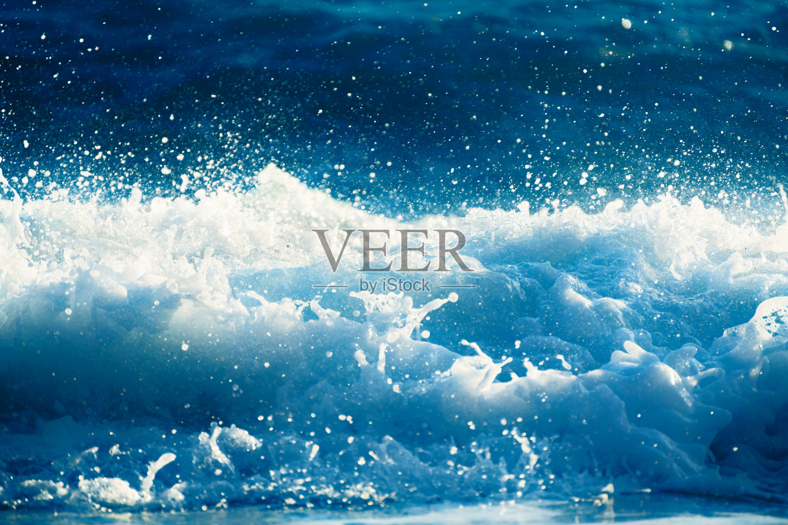 海浪的飞溅与泡沫近距离。抽象海浪背景。照片摄影图片