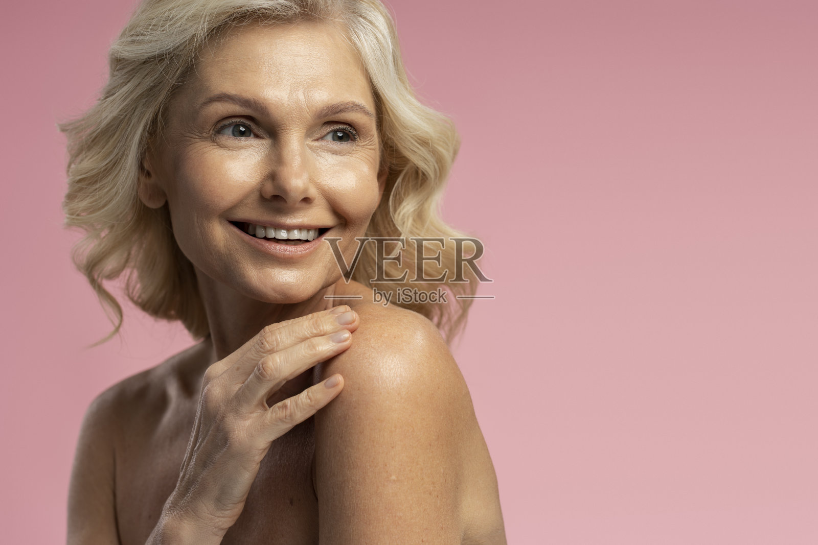 白种50多岁的成熟女人手挽在肩上，微笑着露出美丽的牙齿照片摄影图片