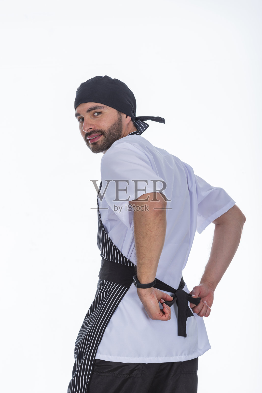 医生在白色照相馆展示他的防流体制服。照片摄影图片