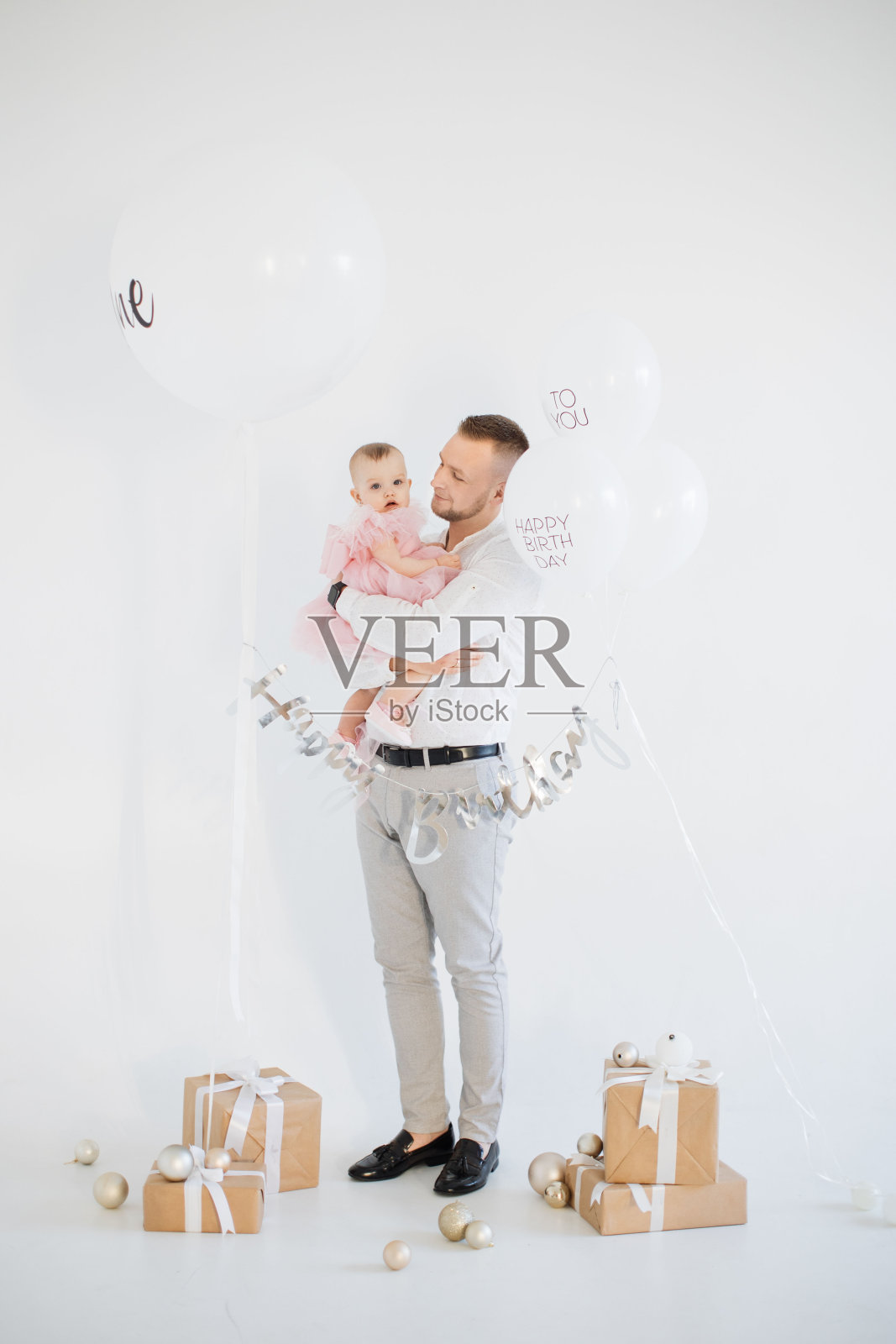 女儿一岁生日时，爸爸温柔地拥抱着她照片摄影图片