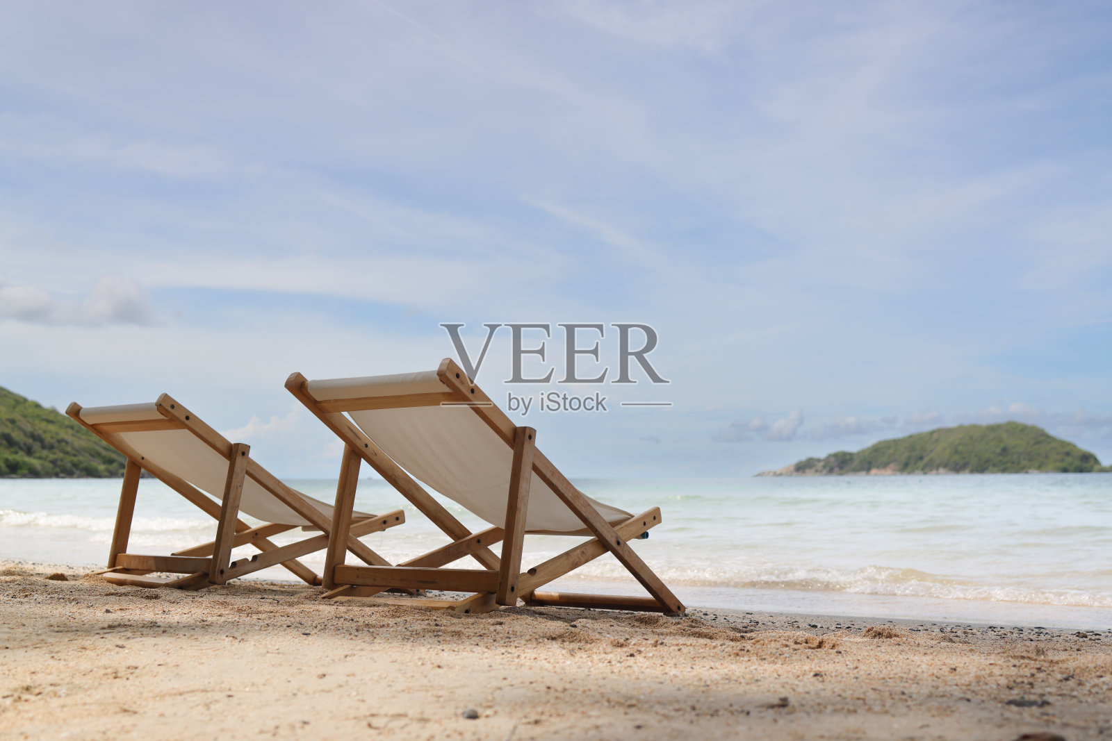 热带沙滩上的白色日光浴椅，暑假照片摄影图片