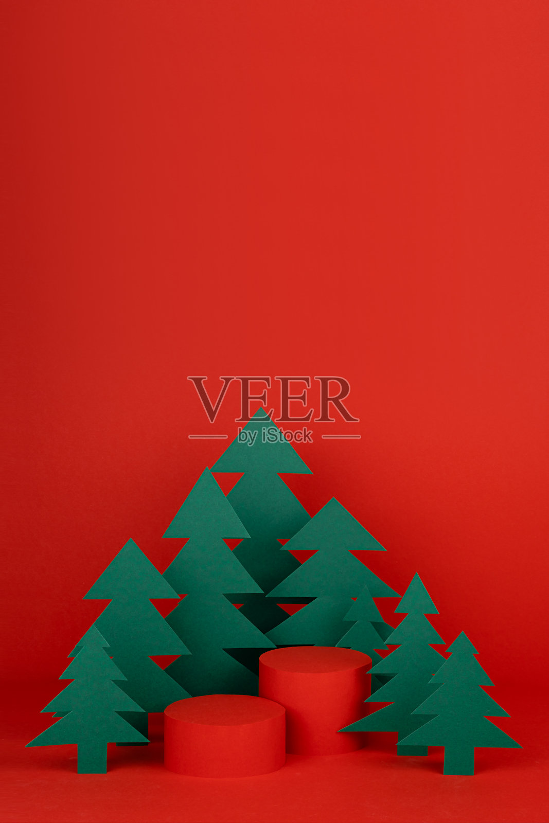 节日新年和圣诞舞台用两个红色圆柱讲台样机，绿色纸云杉为森林展示化妆品产品，礼品，商品，设计，海报，卡片，传单，垂直。照片摄影图片