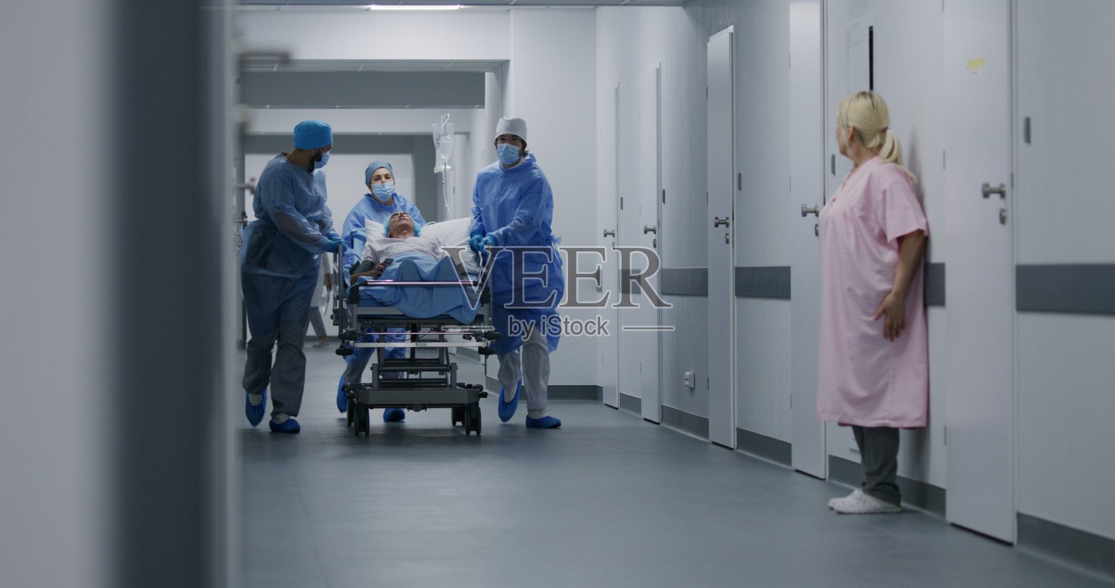 医护人员推着轮床把病人送到手术室照片摄影图片