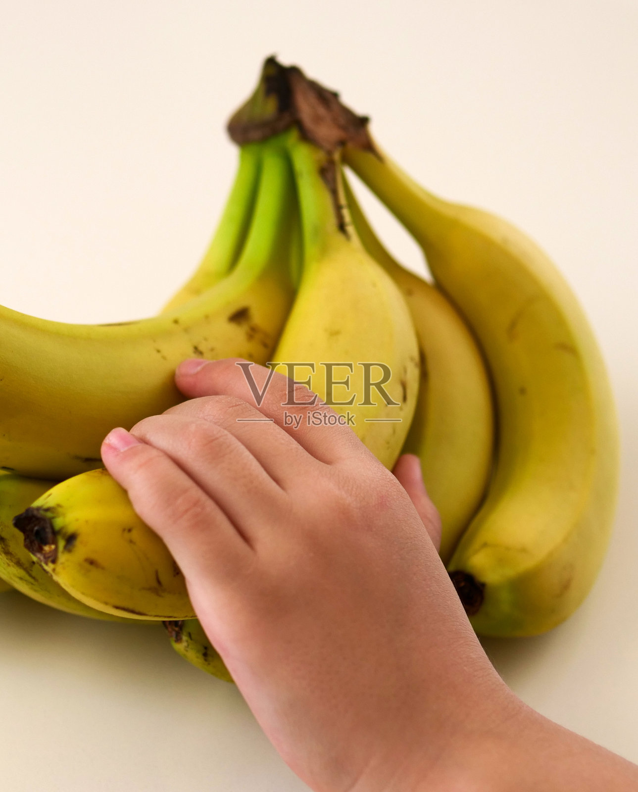 一个小孩摸香蕉，一个小孩伸手去拿香蕉，照片摄影图片