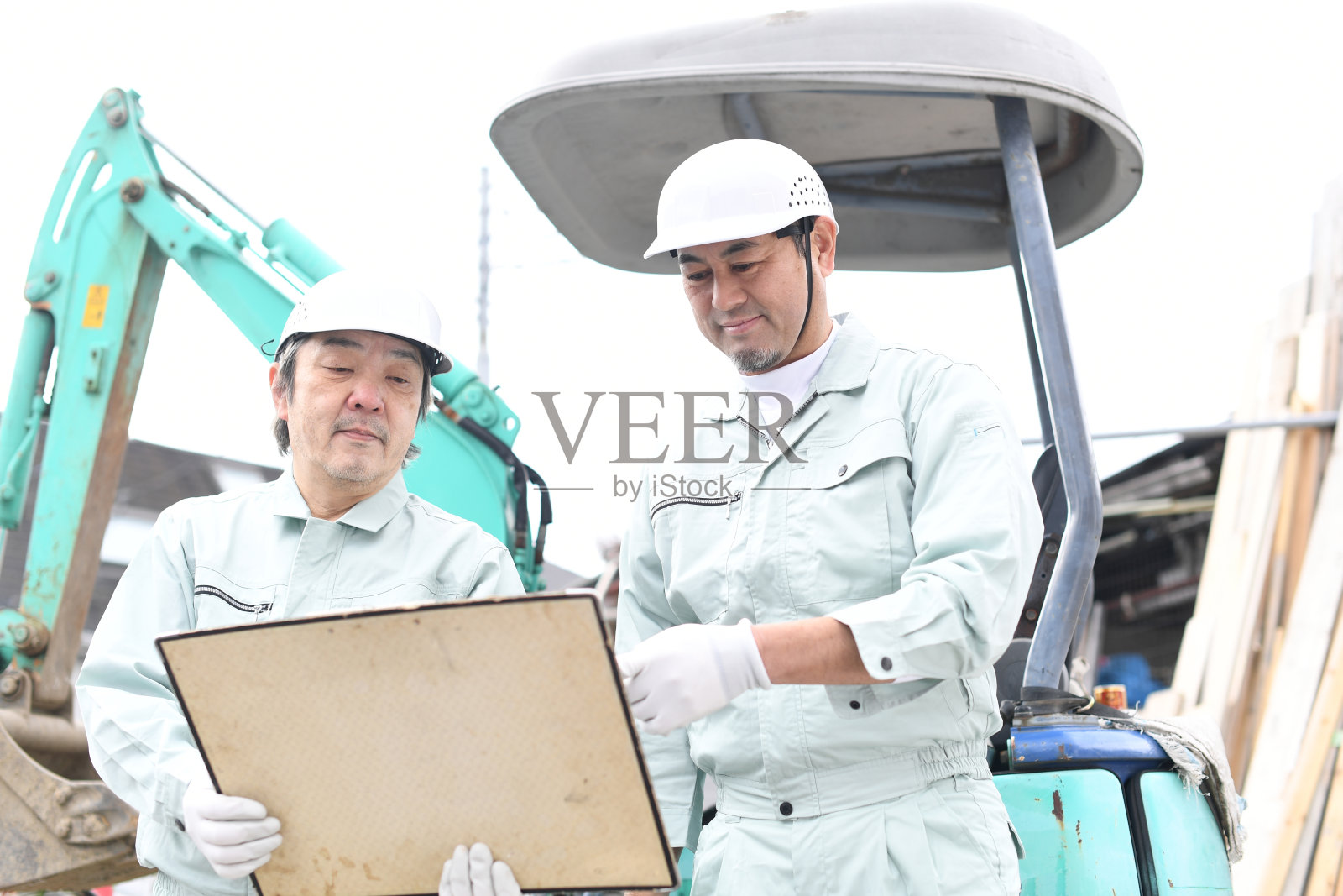 正在建筑工地开会的中年亚洲男性工人照片摄影图片