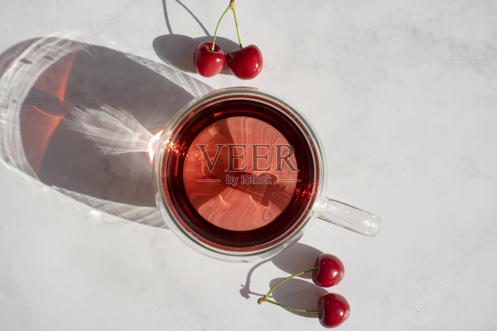 在清淡的背景下搭配新鲜樱桃饮用照片摄影图片