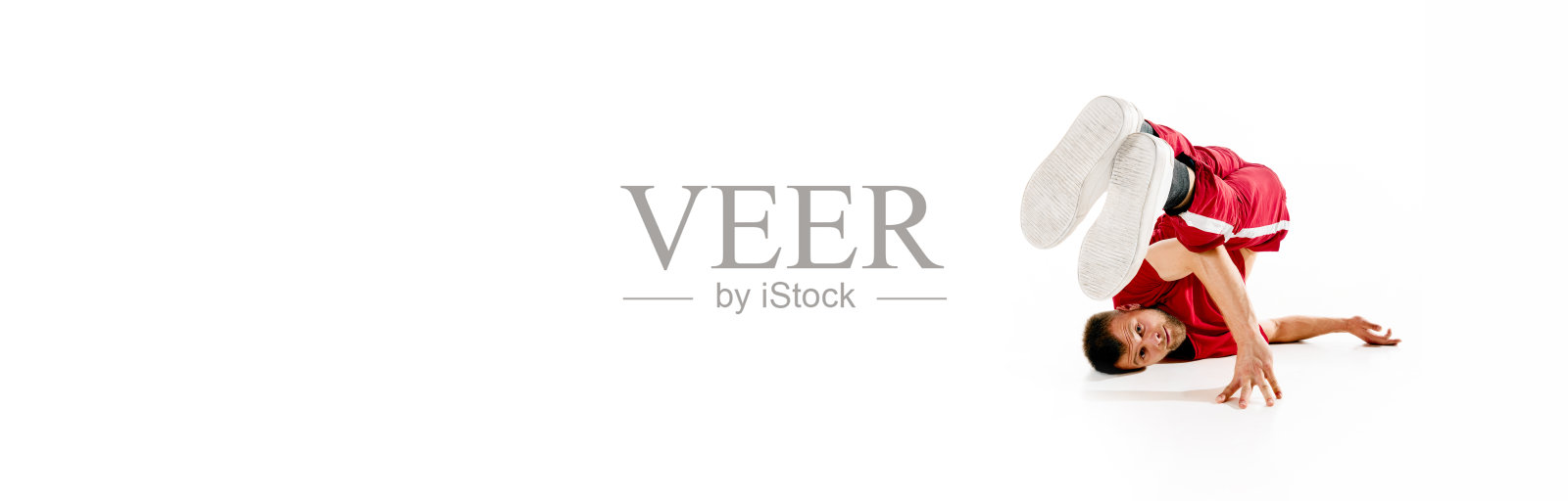 横幅。时尚的肖像。穿着时尚活泼的年轻男子表演舞蹈，自由式，霹雳舞运动在白色的背景。照片摄影图片