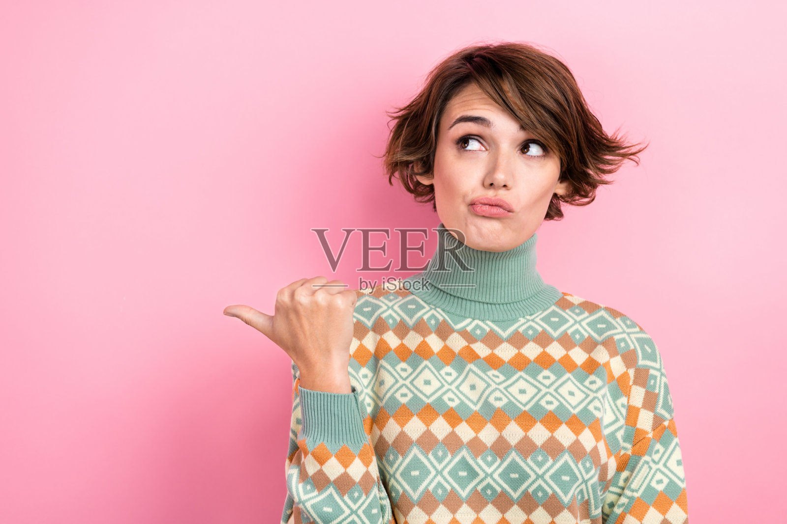 头脑漂亮的女孩的肖像直接看拇指手指空白的空间犹豫沉思孤立在粉红色的背景照片摄影图片