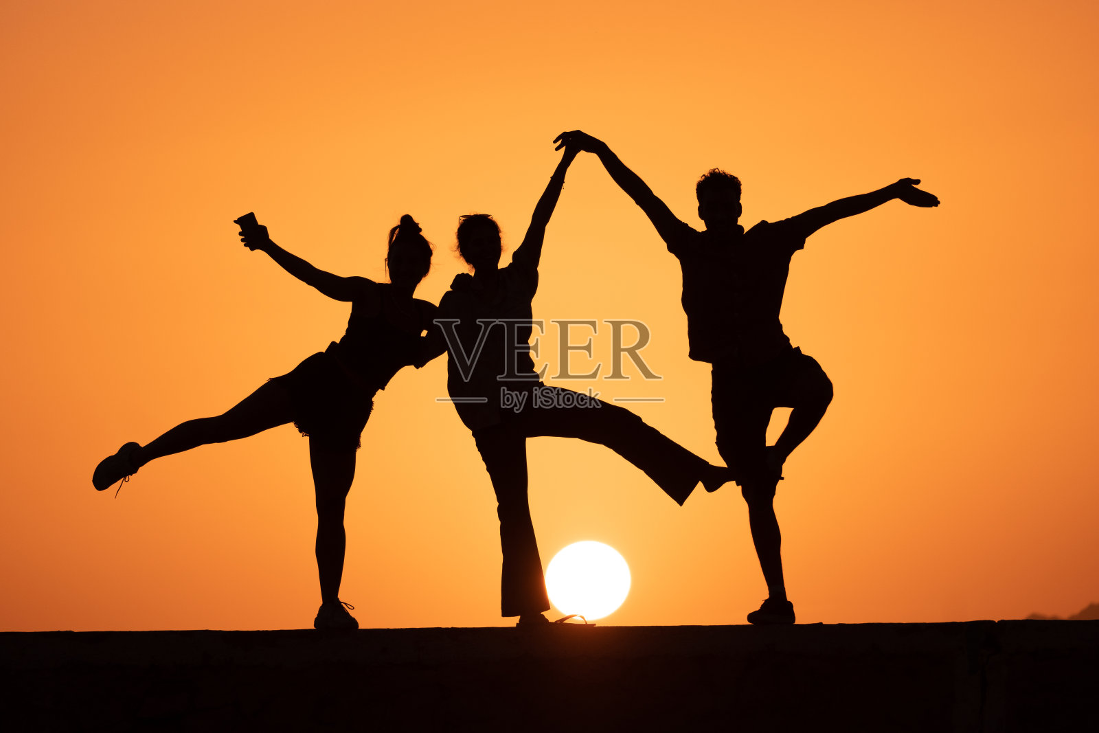 朋友们在日出时走过沙丘照片摄影图片