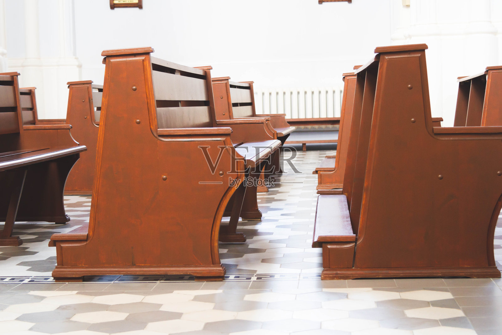 人们在教堂祈祷。教堂教区。信徒们坐在大厅的长椅上。照片摄影图片