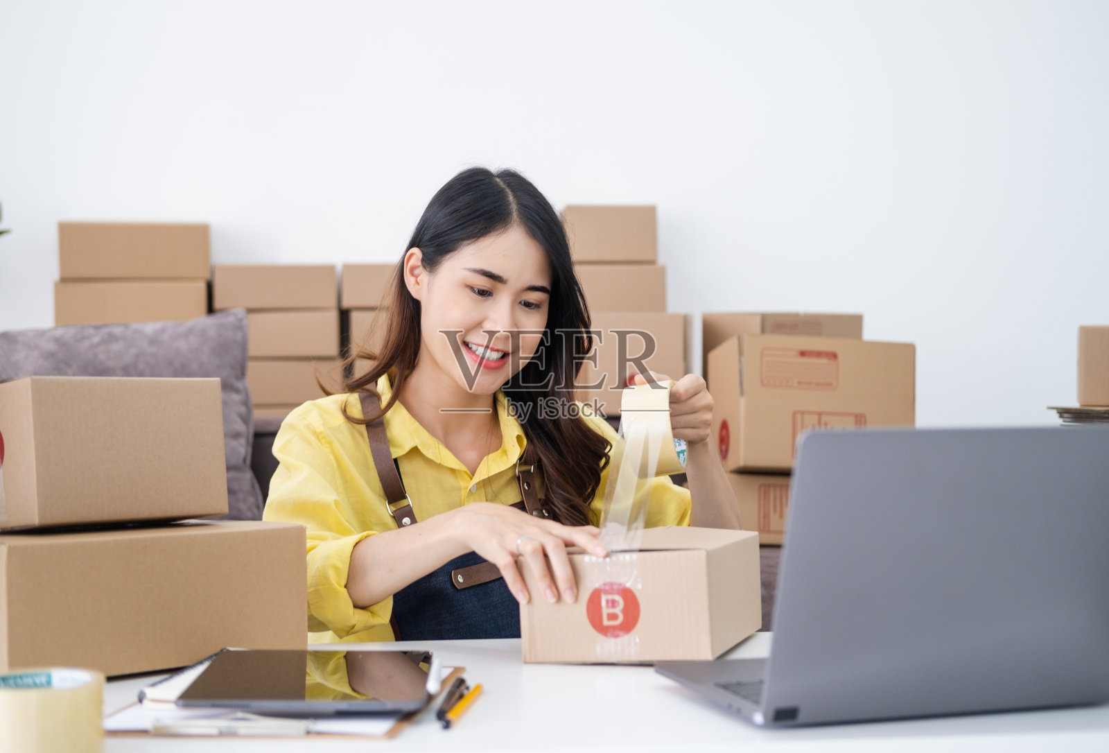 小型企业家开始一个家庭企业安排货物与棕色包裹箱，小型家庭企业创业的想法。照片摄影图片