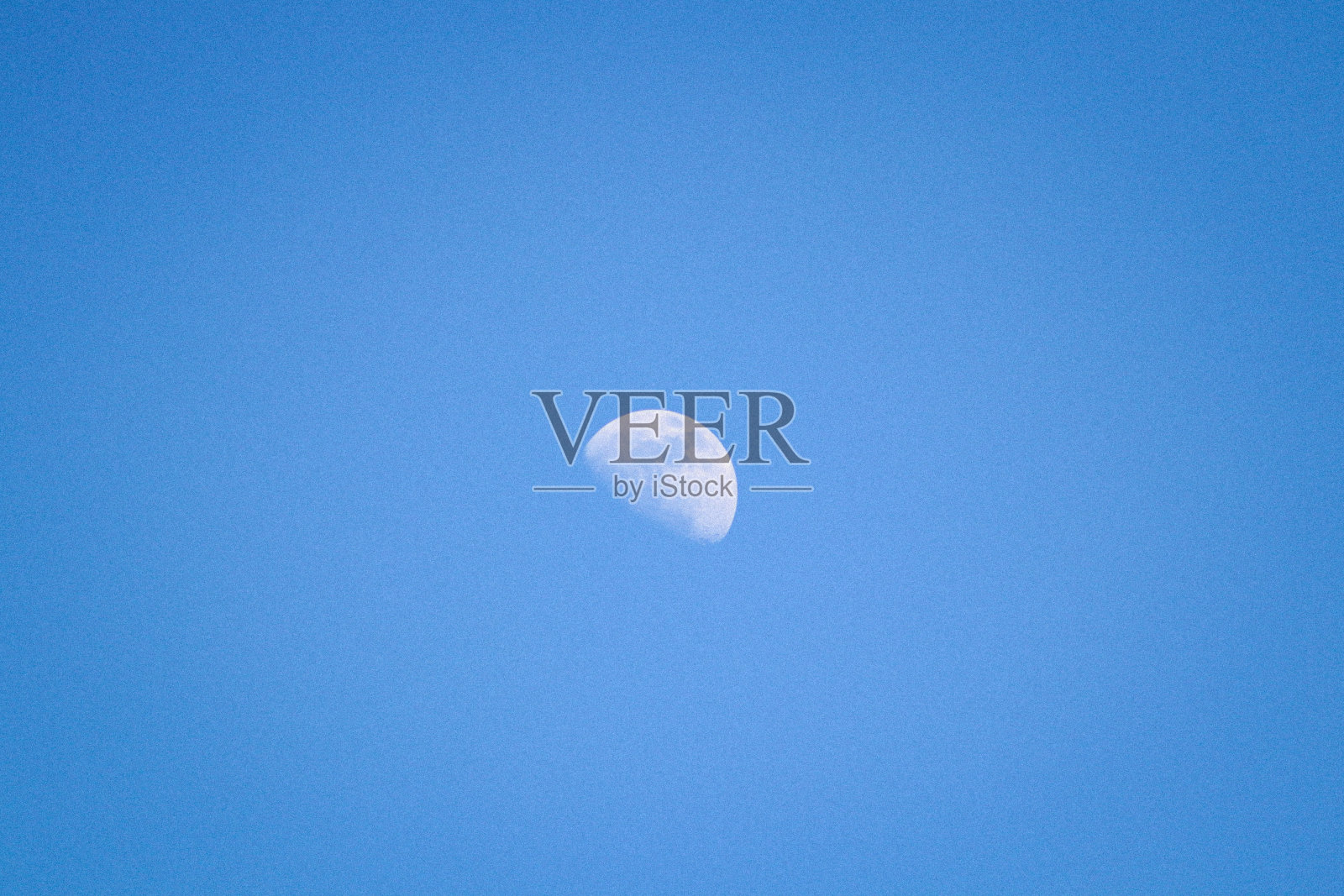 照片中的月亮在蓝天上，白天照片摄影图片