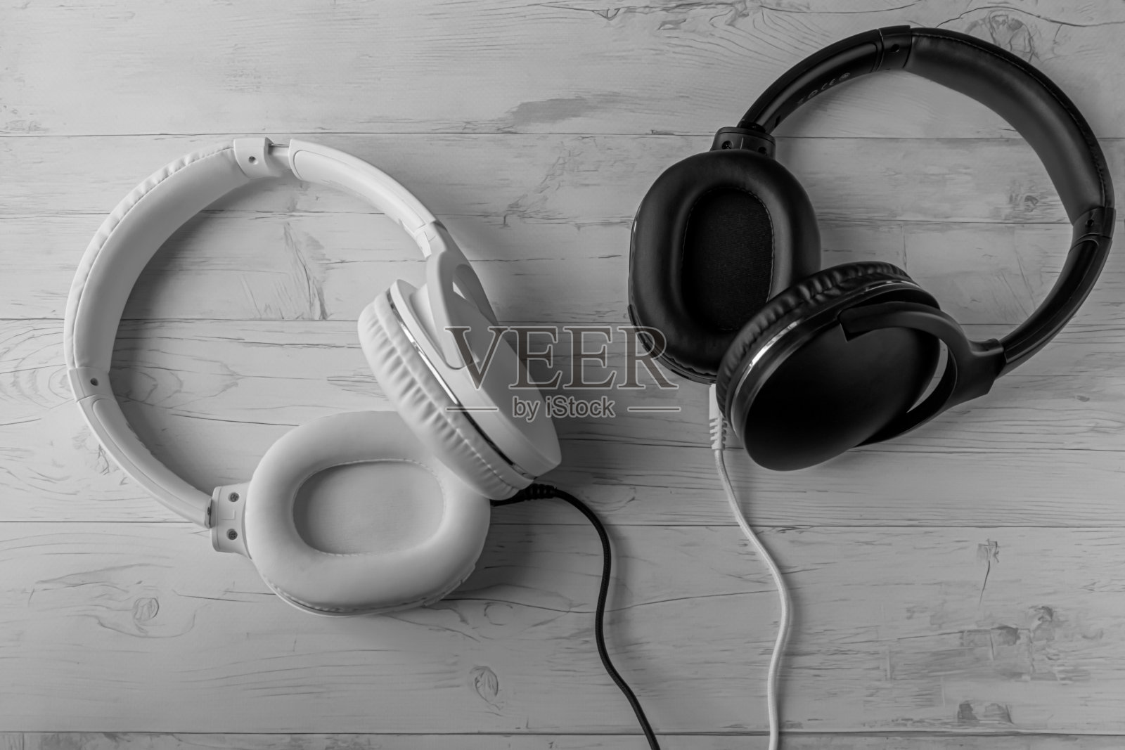 黑色和白色耳机在浅色木制背景照片摄影图片