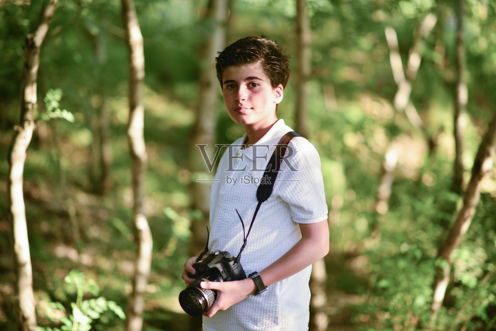 小摄影师走在森林里照片摄影图片