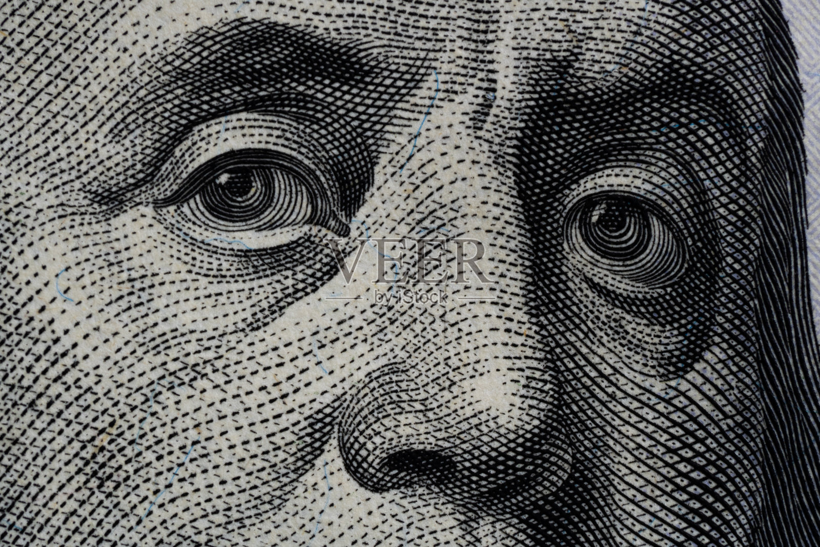 本杰明·富兰克林的眼睛从一张一百美元的钞票上。百元钞票上本杰明·富兰克林的眼睛，背景，特写。印着本杰明·富兰克林眼睛的100美元钞票。照片摄影图片