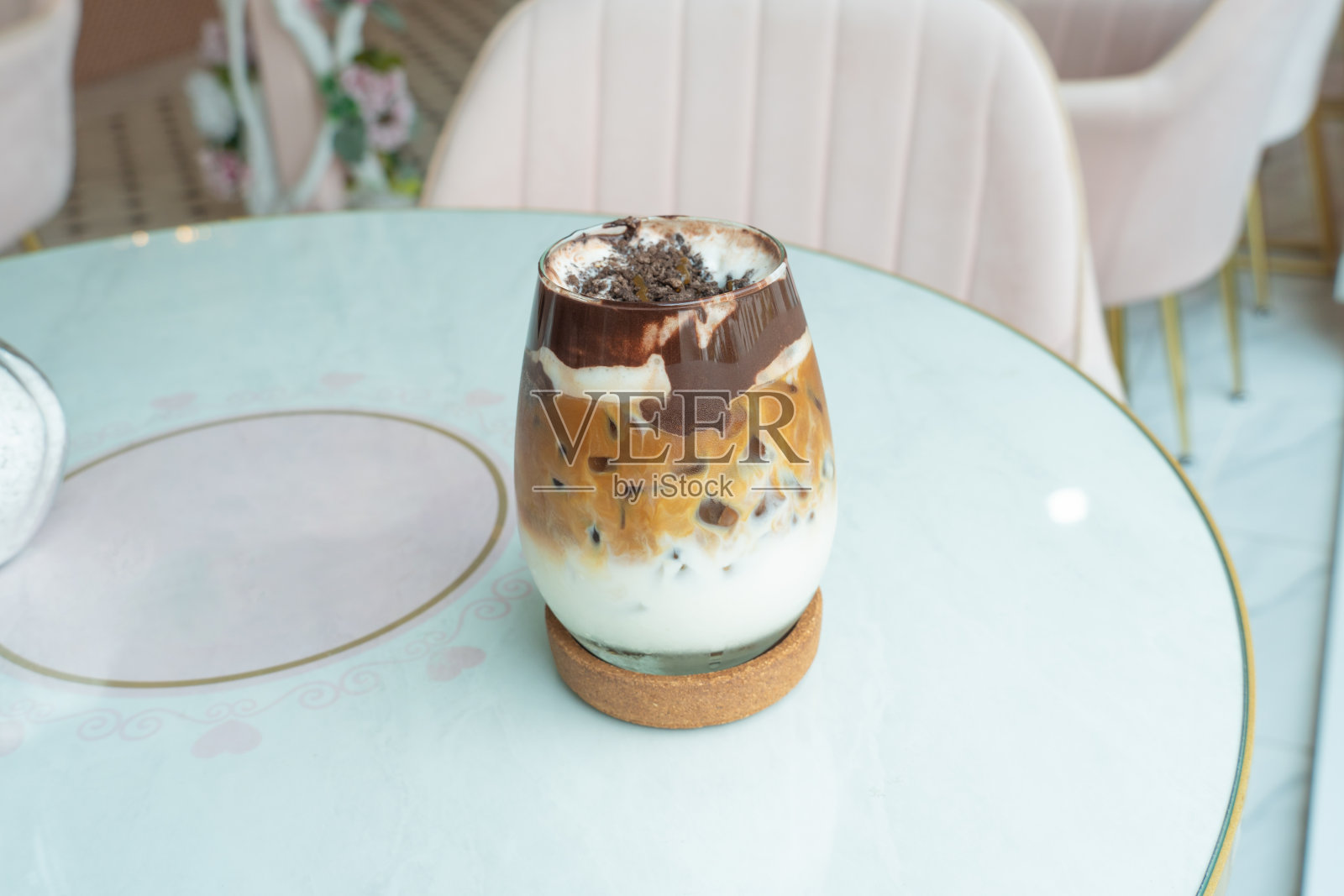 冰巧克力咖啡，奶油巧克力酱，白色桌子上的透明玻璃。文字，黑色，可可，棕色，牛奶混合饮料的复制空间。菜单餐厅，咖啡馆，冰，玻璃在白色背景。照片摄影图片