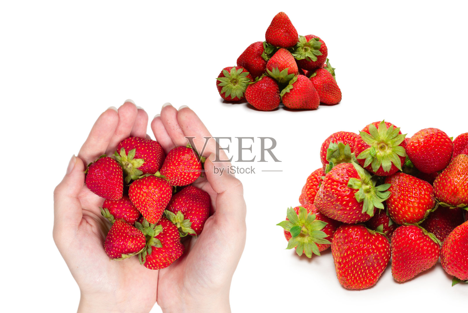 草莓拿在手里，孤立在白色的背景上。照片摄影图片