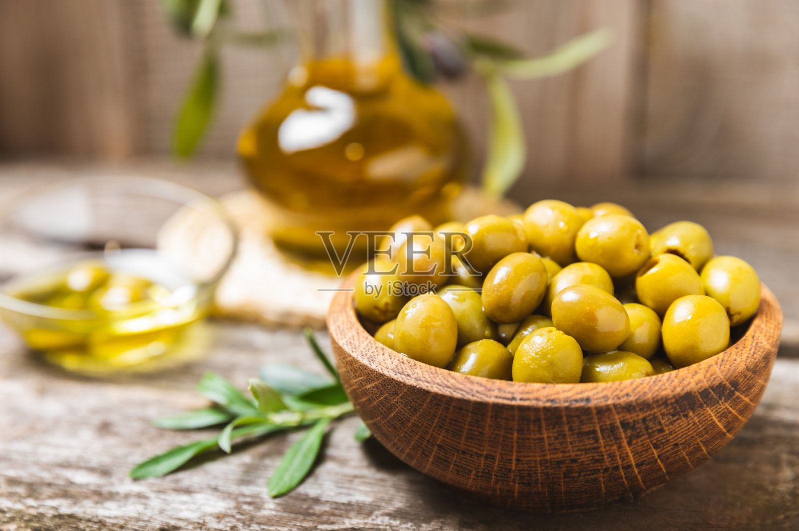 背景是一组绿、红、黑橄榄。碗里有各种各样的橄榄和新鲜的橄榄叶。素食主义者。橄榄果实。放文字的地方。副本的空间。照片摄影图片