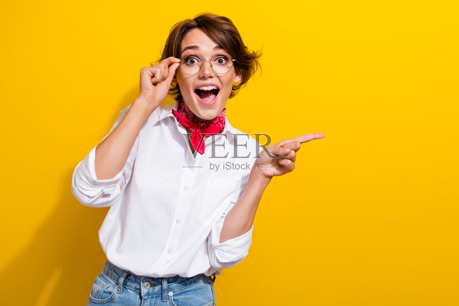 疯狂惊奇的女孩的照片有趣的人指着空白的空间意想不到的魅力精品提供孤立的黄色背景照片摄影图片