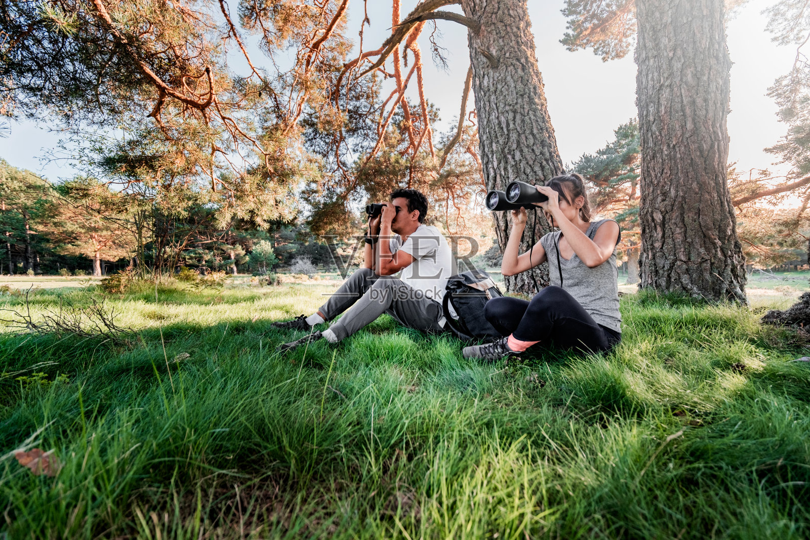 几个探险家在野外用望远镜寻找动物。照片摄影图片
