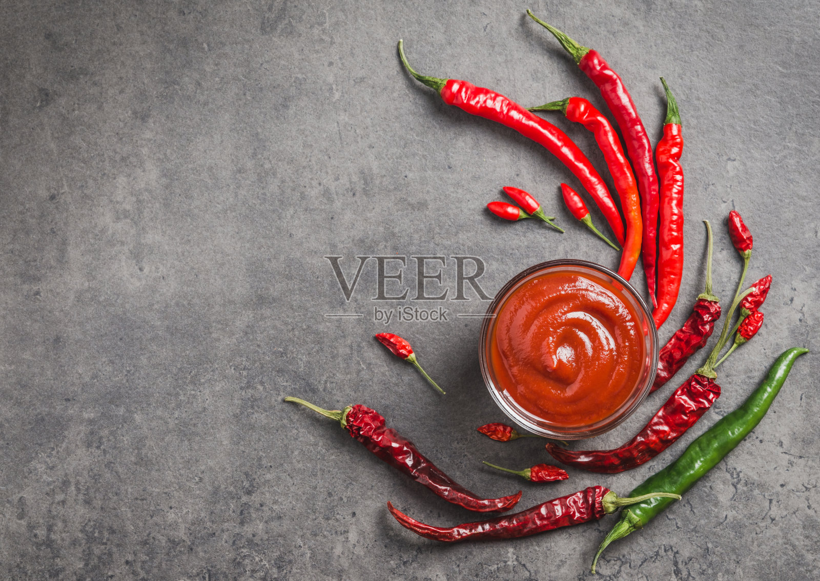 辣椒酱番茄酱在碗和新鲜辣椒在暗背景复制空间。辣番茄酱。照片摄影图片