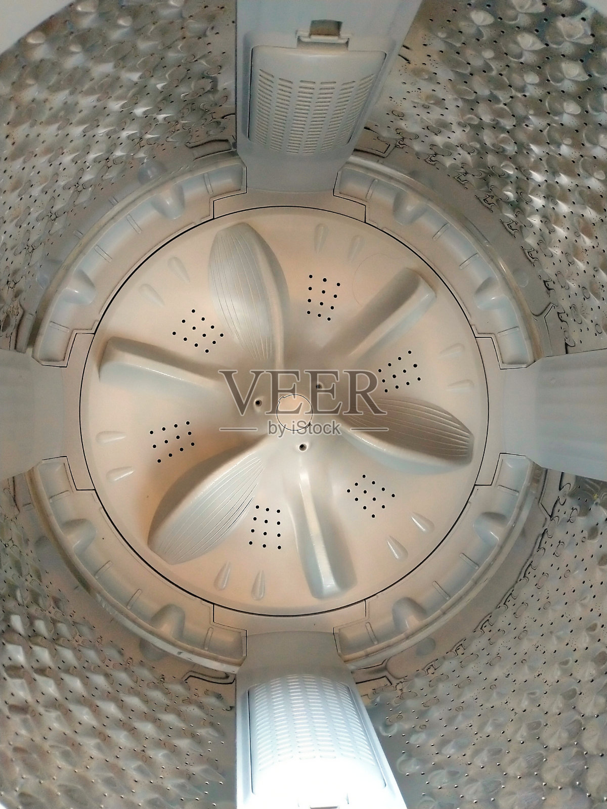 洗衣机滚筒上的旋转驱动装置照片摄影图片