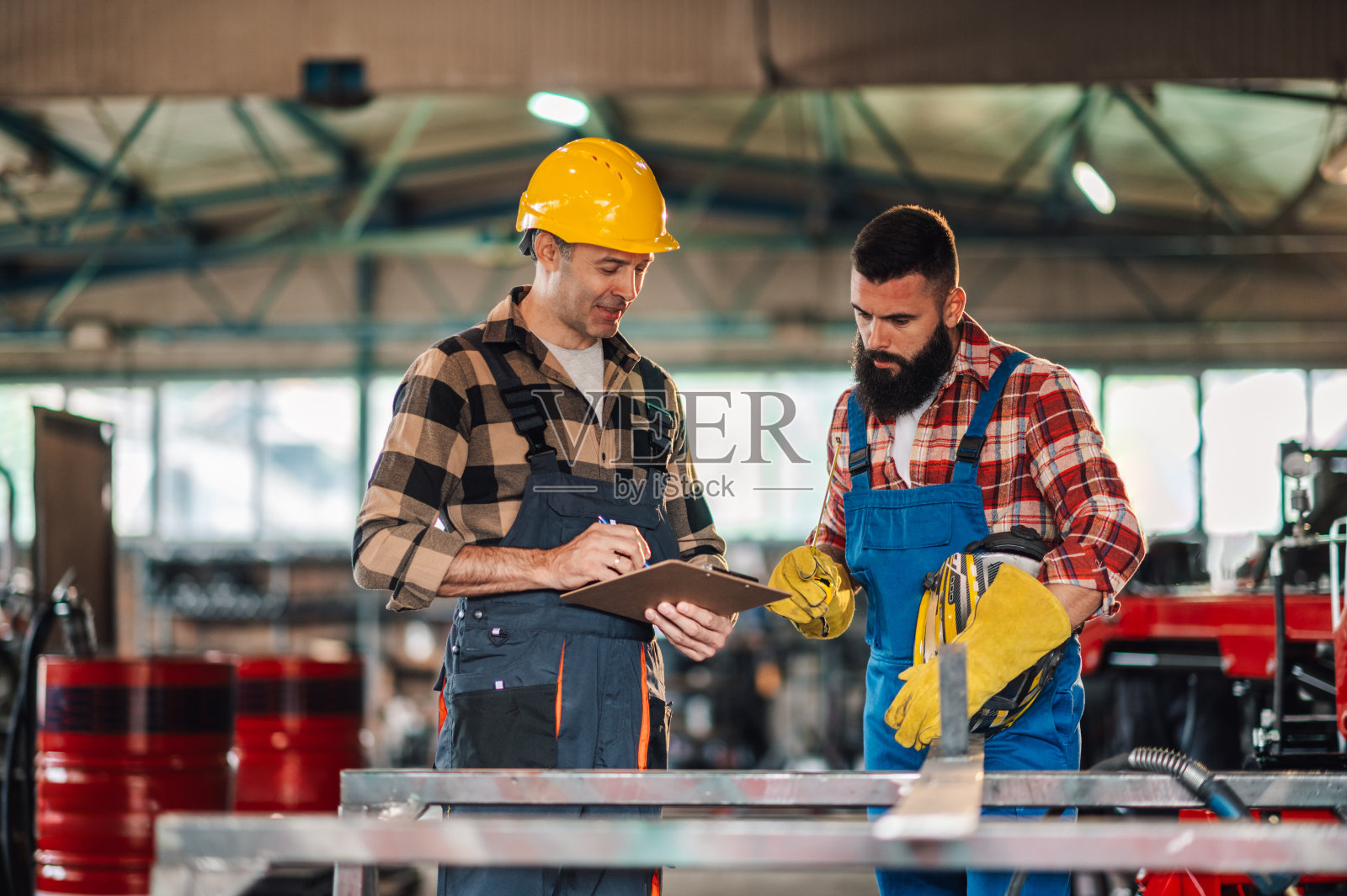 两位同事在开始工作前低头看笔记。照片摄影图片