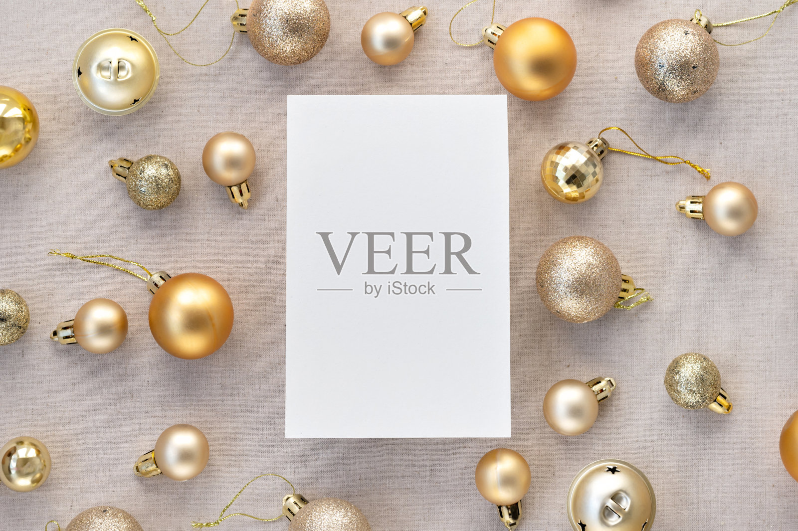 空白纸卡模型，金色粉彩圣诞树装饰球，中性米色亚麻背景上的装饰品图案。审美节日商业品牌，社交媒体博客模板照片摄影图片