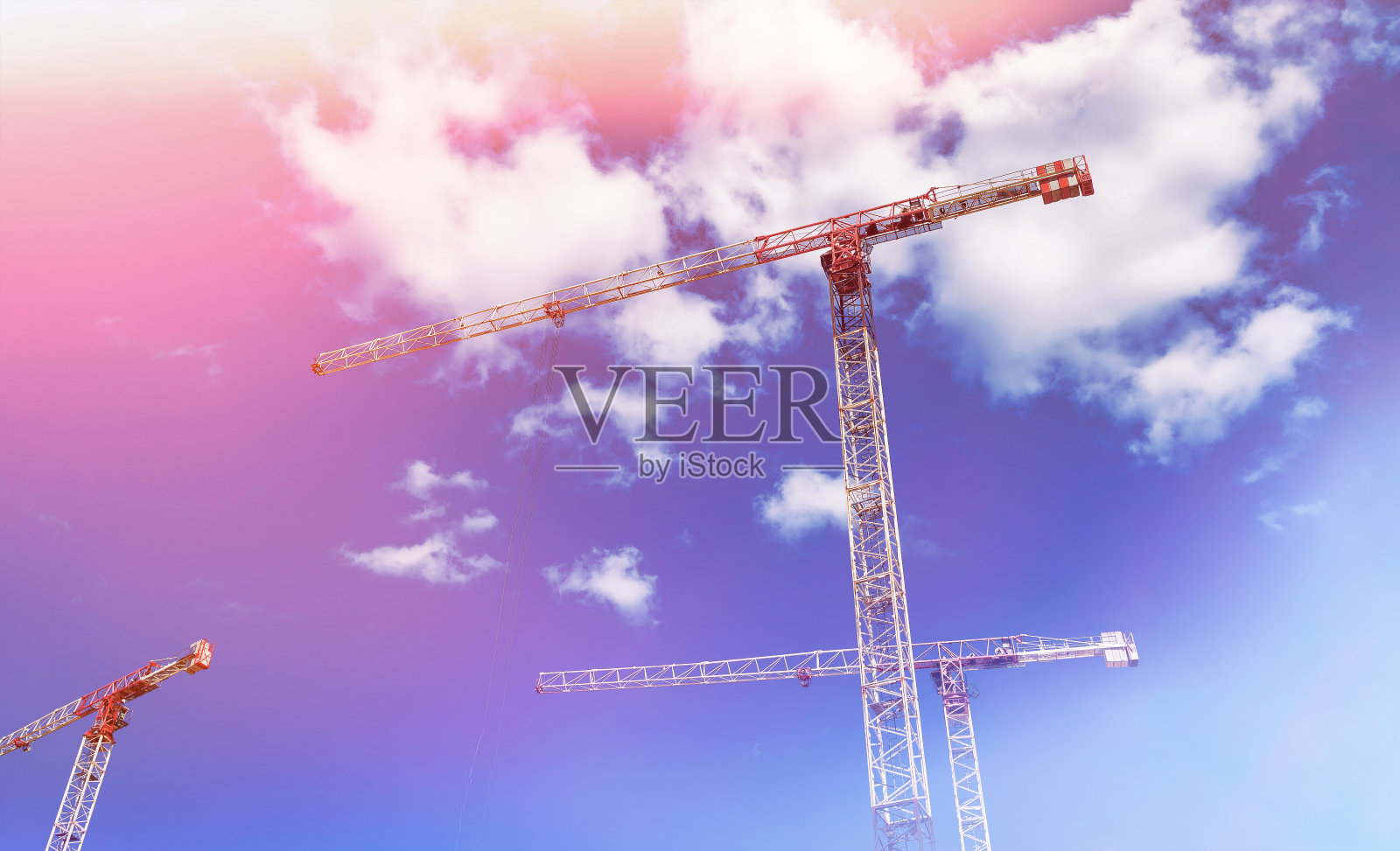 建筑起重机在创作现场工作，蓝天为背景照片摄影图片