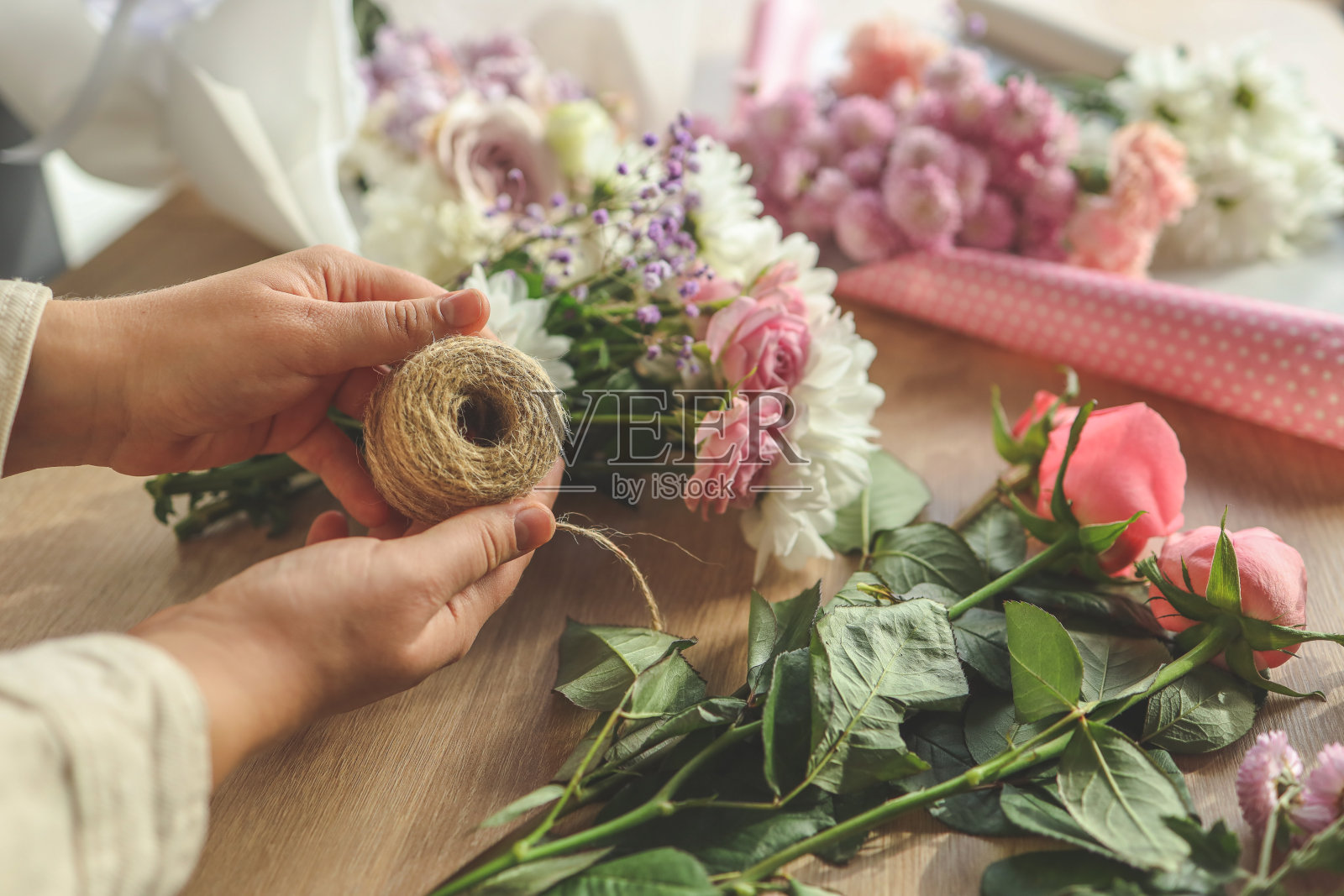 花店老板上班了。制作秋季花卉装饰的妇女照片摄影图片
