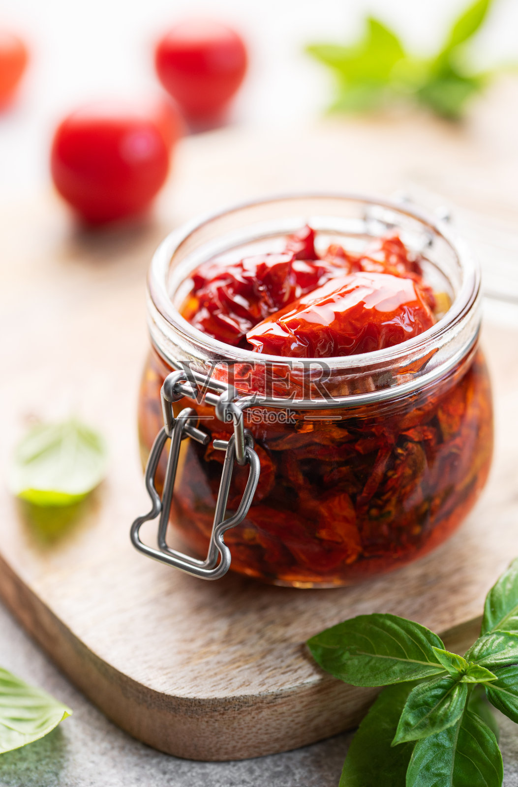 将晒干的番茄与新鲜的香草和香料混合。照片摄影图片