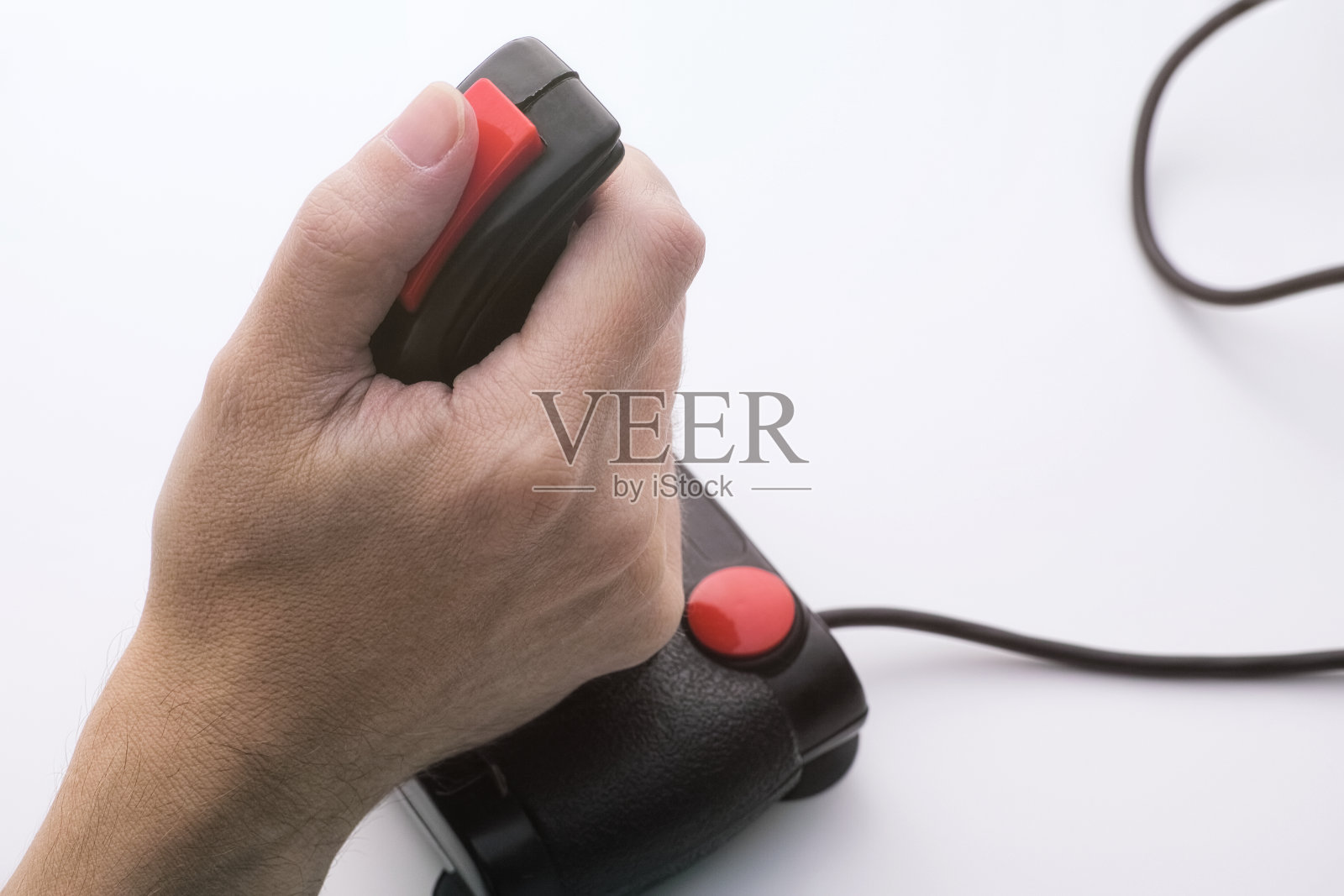 一个拿着复古摇杆玩电子游戏的男人。80年代中期的游戏操纵杆照片摄影图片