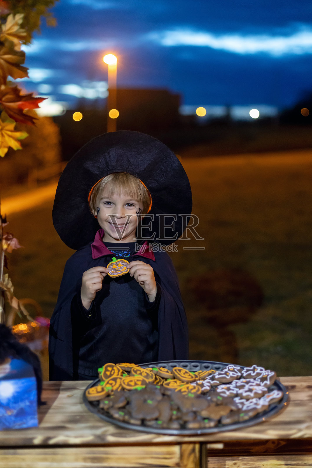 孩子们，晚上在户外庆祝万圣节，德古拉，吸血鬼，木乃伊，南瓜照片摄影图片