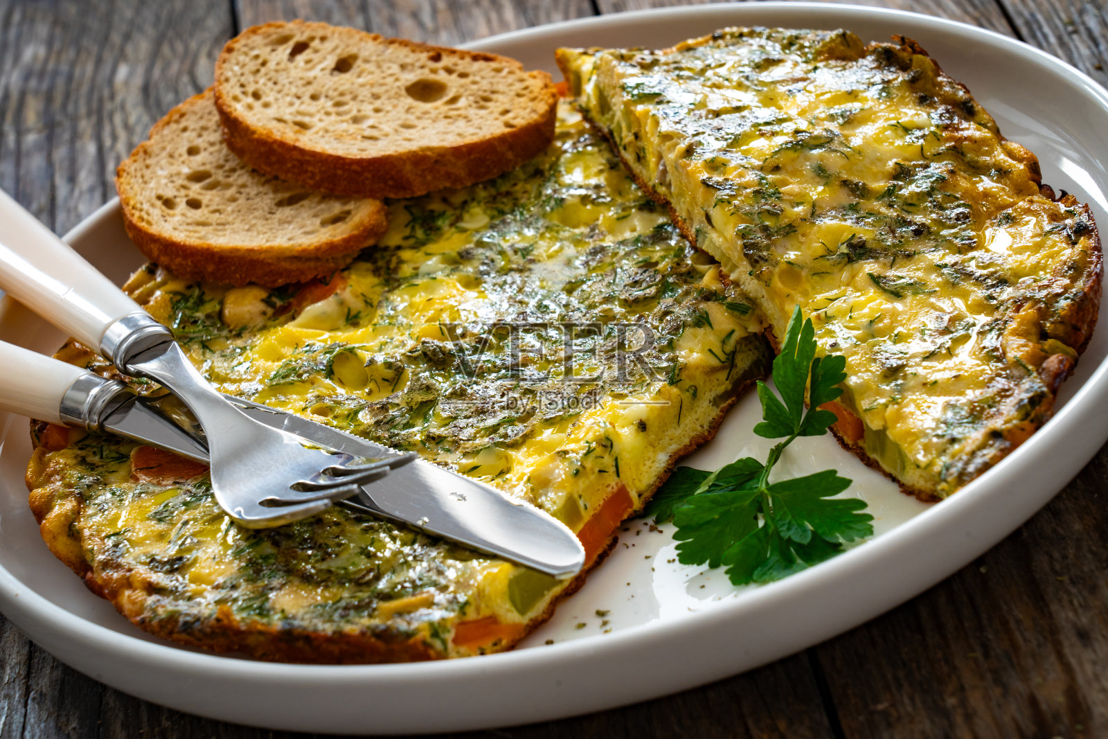 煎蛋卷——在木桌上用奶酪和蔬菜炒鸡蛋照片摄影图片