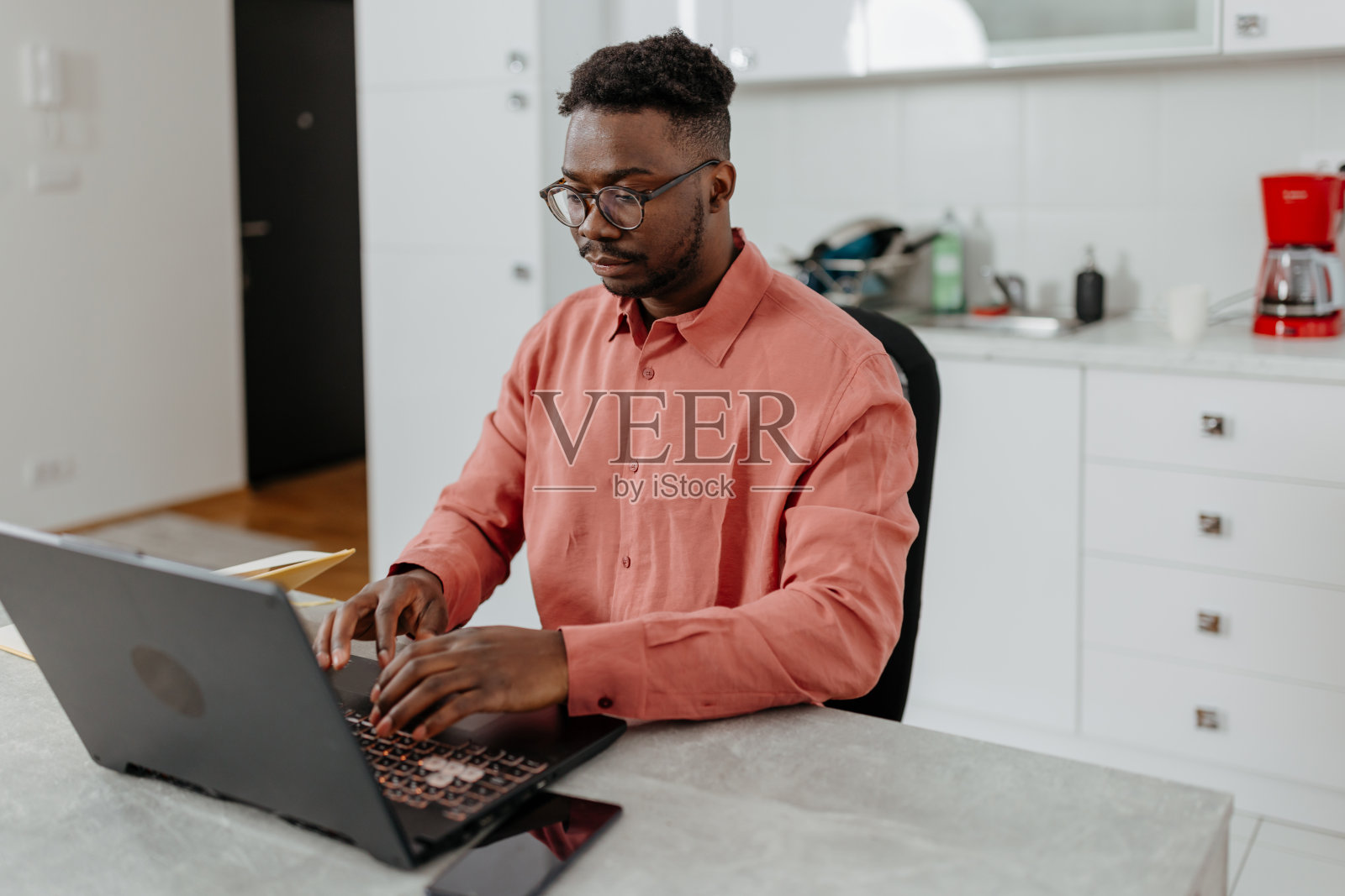 非裔美国专业人士在他的家庭工作空间中利用技术的力量照片摄影图片