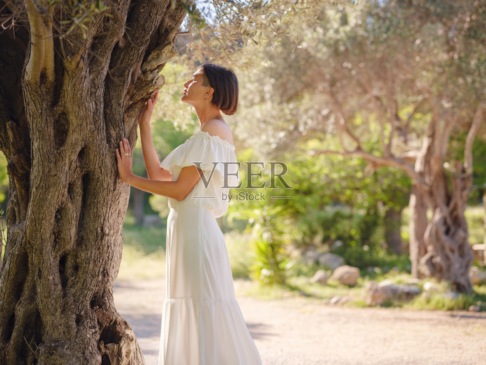 美丽的亚洲年轻女子在户外穿着白色连衣裙照片摄影图片