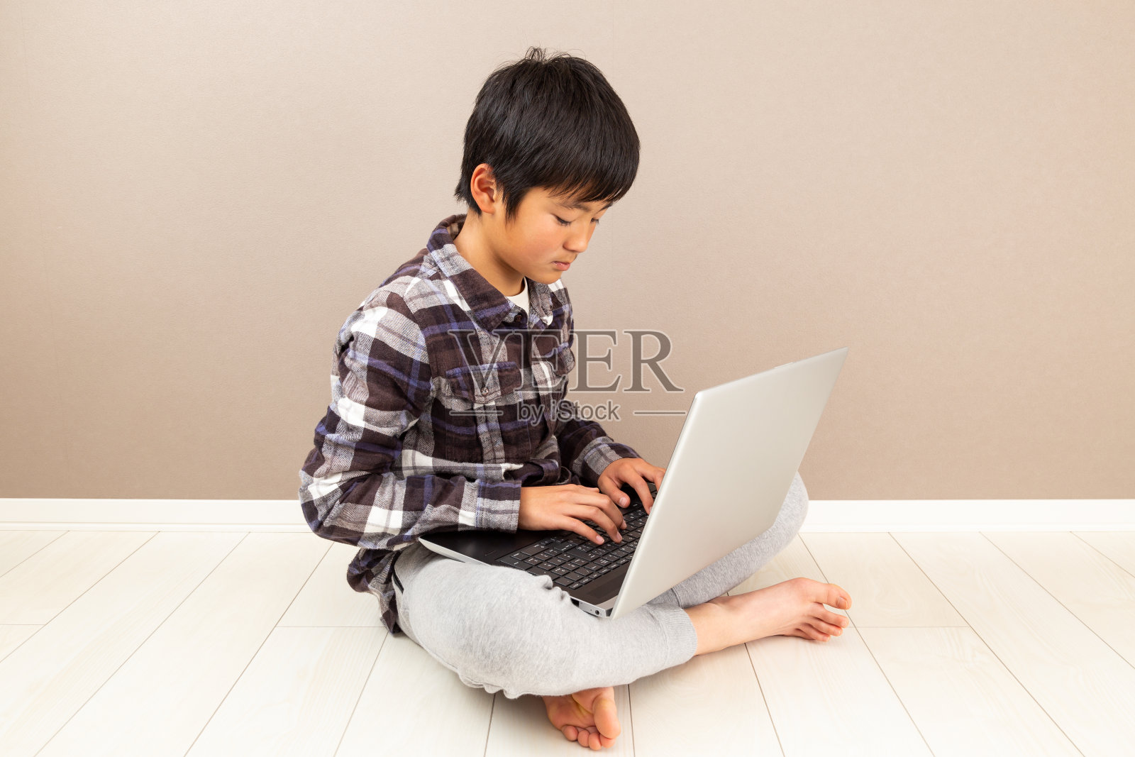 一个孩子在使用笔记本电脑。照片摄影图片