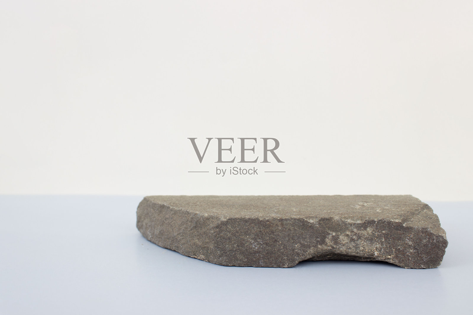 空的自然平坦的灰色石头讲台在灰蓝色的背景。复制空间，文本的位置。照片摄影图片