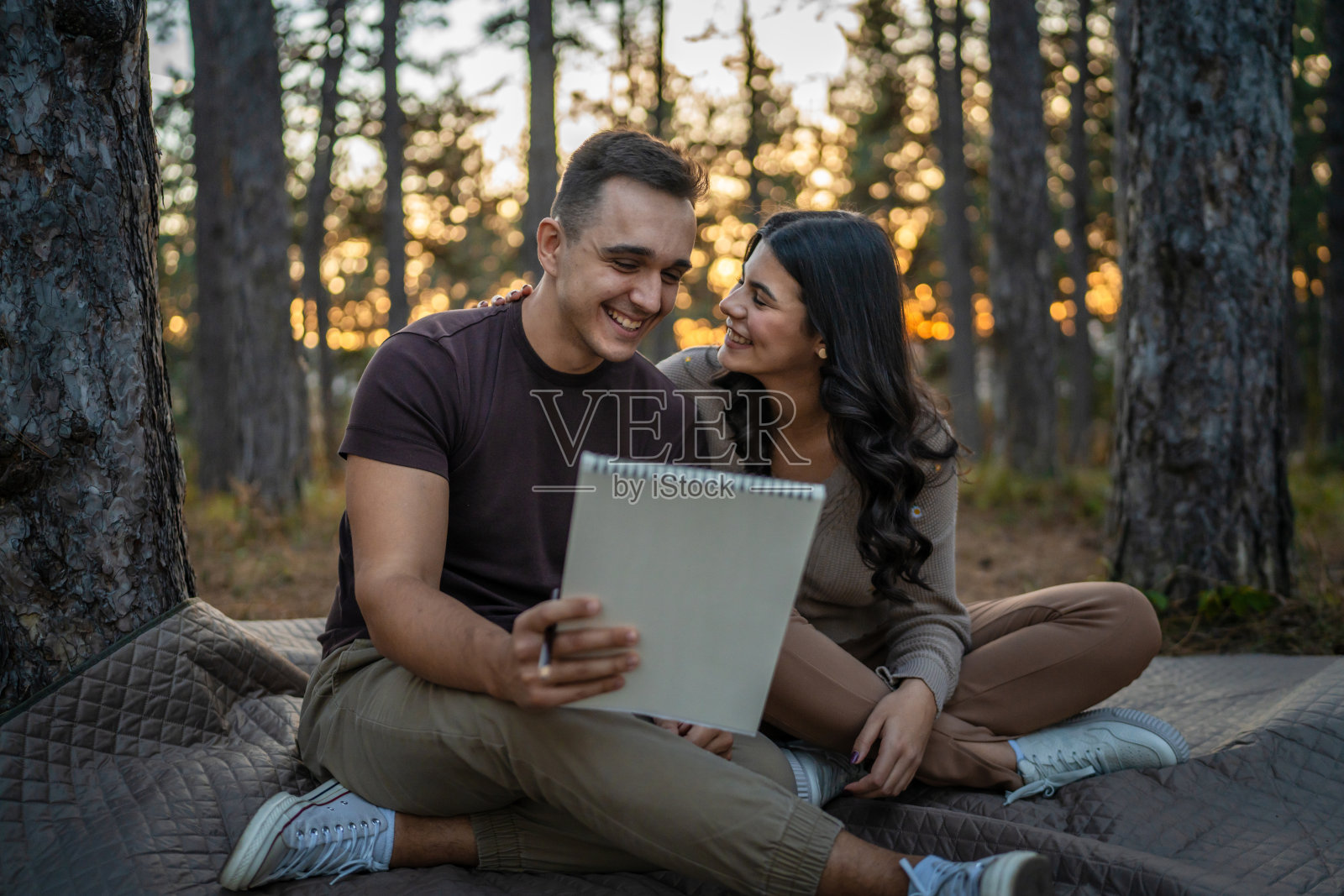 男人和女人，年轻的成年夫妇在大自然中抱着，画着照片摄影图片