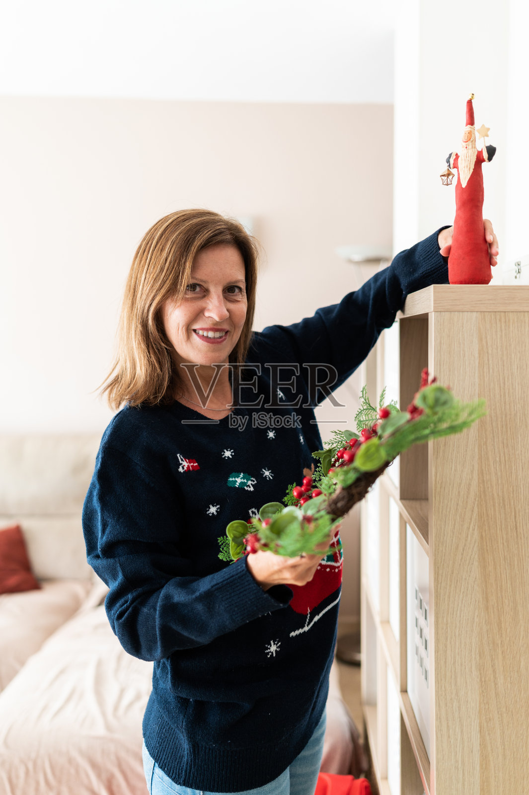 用圣诞装饰品装饰房子的妇女照片摄影图片
